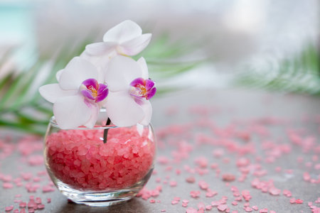 Pink orchid in a vase with pink sea salt close-up. Spa and wellness conceptの写真素材