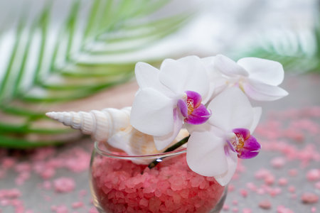 Pink orchid in a vase with pink sea salt close-up. Spa and wellness conceptの写真素材