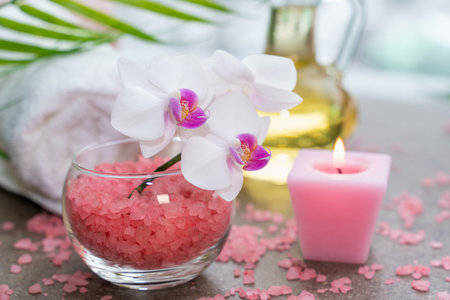 Starfish, seashells, terry towel, candle and plant on the sand. Spa and wellness conceptの写真素材