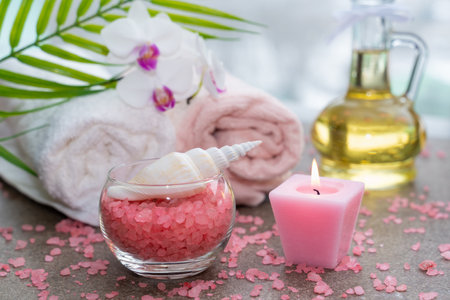 Starfish, seashells, terry towel, candle and plant on the sand. Spa and wellness conceptの写真素材