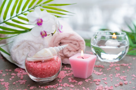 Starfish, seashells, terry towel, candle and plant on the sand. Spa and wellness conceptの写真素材