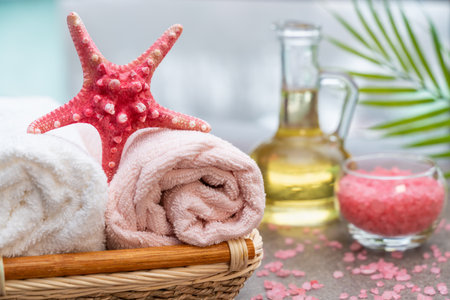 Starfish, seashells, terry towel, candle and plant on the sand. Spa and wellness conceptの写真素材
