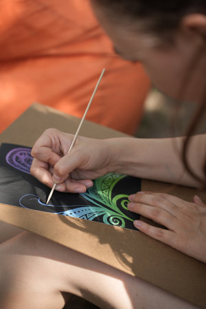 The girl is engaged in meditative drawing - scratch paintingの写真素材