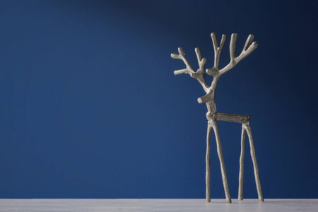 Souvenir silver deer on a blue backgroundの写真素材