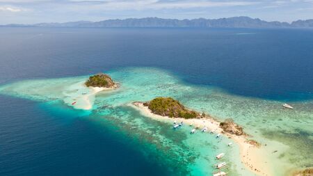 Small torpic island with a white sandy beach, top view.Islands Bulog Dos.Tourist routes of the...