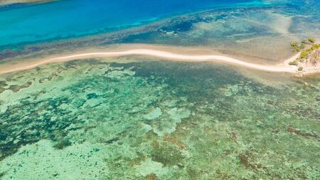 Sea bottom with sand bar.lagoon with coral reefs and a small island aerial viewの写真素材