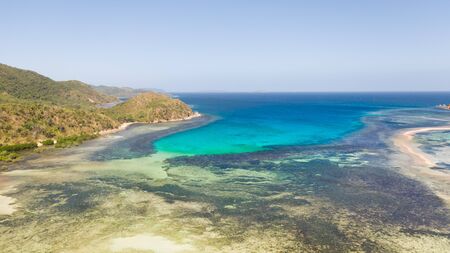 SmSmall islands with a sand bar. Coral reefs and blue lagoons. islands with a sand bar. Malay...