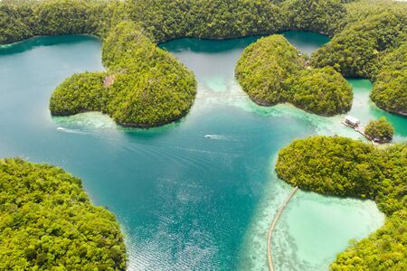 Cove and blue lagoon among small islands covered with rainforest. Sugba lagoon, Siargao, Philippines. Aerial view of Sugba lagoon, Siargao,Philippines.の写真素材