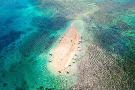 Naked Island, Siargao. The island of white sand on the atoll. Tourists relax on the white island. Seascape with sandy island.の写真素材