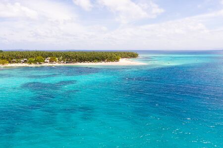 Beautiful tropical island in sunny weather, view from above. Daco island, Philippines. White sandy...
