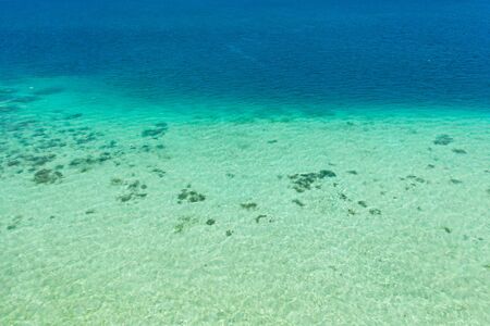 Coral reefs and atolls in the tropical sea, top view. Turquoise sea water and beautiful shallows. Philippine nature. Sea surface.の写真素材