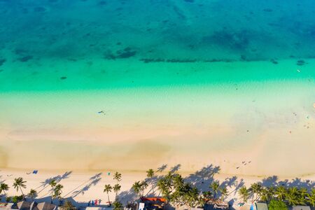 Tropical beach with white sand and palm trees, view from above. Turquoise lagoon with a sandy bottom. Beach of the island of Boracay, Philippines.の写真素材