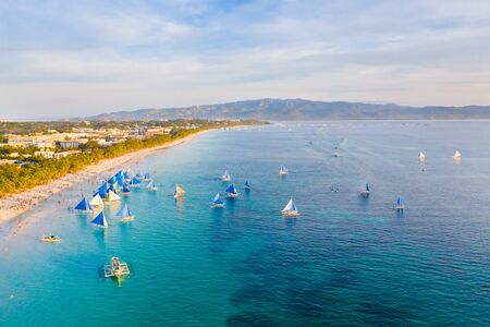 Small sailing boats for touristic excursions at sunset in Boracay island - Exclusive travel...