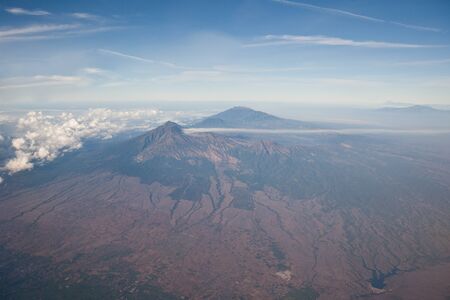 Mountain peaks of Indonesia, the view from the plane. Volcanoes of Indonesia.