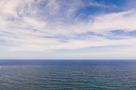 Seascape by day. Sea and sky with clouds in calm weather.の写真素材