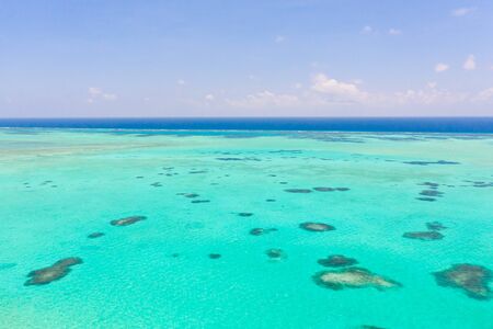 Sea water with lagoon and reefs, water background. Seascape with clear water. Large atoll with lagoon.の写真素材