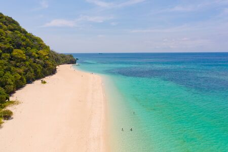 Puka Shell Beach. Wide tropical beach with white sand. Beautiful white beach and azure water on Boracay island, Philippines, top view. Tourists relax on the beach.の写真素材