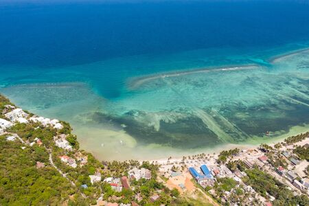 Island Boracay, Philippines, view from above. White beach with palm trees and turquoise lagoon with...