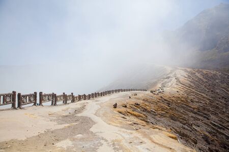 Ijen Volcano, Indonesia. Workers mine sulfur from the crater of the volcano. Sulfur mining.