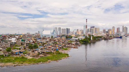 Slums of poor people on the background of a big city. The city of Manila, poor and poor areas....