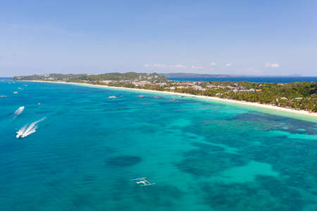 Seascape in the Philippines in sunny weather, view from above. Transparent sea and tourist boats...