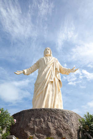 statue of christ the savior at pilgrimage island, hundred islands national park. White statue against the sky.の写真素材