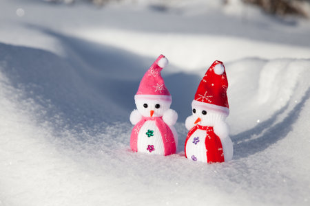 little snowmen in the snow in sunny weather.の写真素材