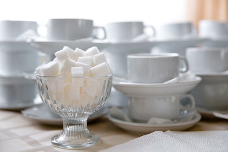 Tea table for the guests of the cafe. Refined sugar and cups for tea.の写真素材