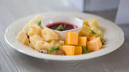 various types of cheese with sauce, Pieces of cheese and sauce on a plate in a restaurant.