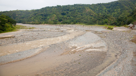 Beauty nature landscape. River in a mountain gorge. Water flow. Tropical trees and mountain river in the Jungle. The nature of the Philippines. Large stones in the river.の写真素材