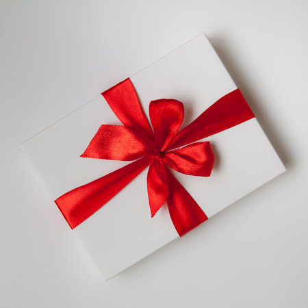 White box, bow and ribbon. Gift on the table close-up.の写真素材