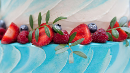 Blue cake with berries. Berries on the cake, close-up. Cake with whipped cream and fresh berries....
