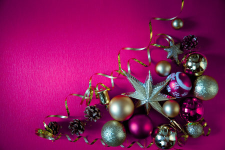 Christmas balls on a dark pink background. New Year card. flat lay. Christmas decorations and a star.の写真素材