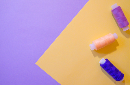 Pastel paper background with threads for design. Purple and yellow.の写真素材