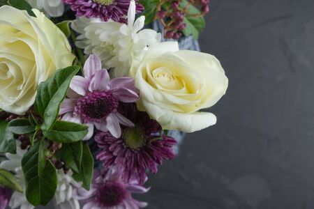 Photo background of white roses, white and purple chrysanthemums. Macro photo flowers.の写真素材