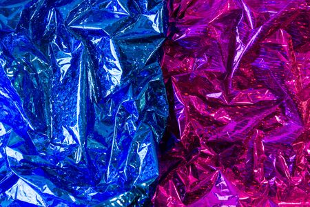 Creative photo background of blue and purple crumpled foil with highlights and shadows