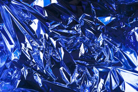 Abstract crumpled foil background. Grunge photo background. Classic Blueの写真素材