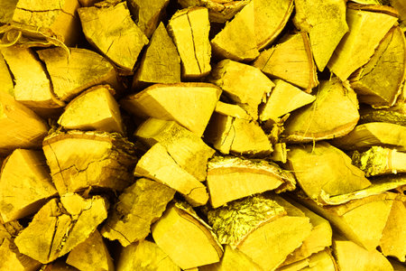 A neatly folded log of chopped wood. Country life. Fire melting. illuminating color of the year 2021の写真素材