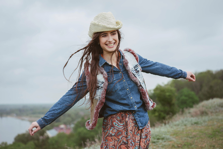youth lifestyle in skirt with patterns and denim shirt in natureの写真素材