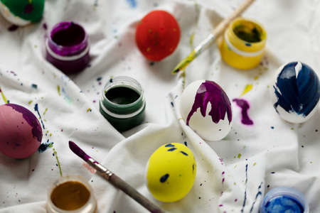 Easter background with colorful eggs and paints on light, DIY, top viewの写真素材