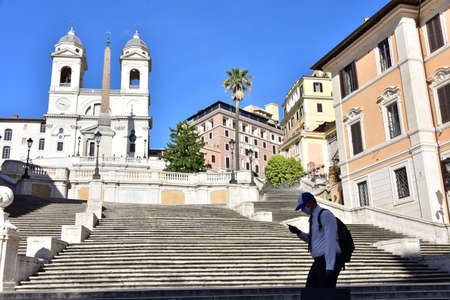 ROME, ITALY - MAY 12: Unknown man in hat and medical mask passes in front of a desert Spanish Steps during Italian lockdown period on May 12, 2020 Rome, RM, Italyのeditorial素材