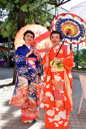 Two japanese girls (singer and actress) in traditional japanese kimono and umbrellas at the event - ROME (Capannelle Hippodrome), 21 MAY 2022 - Japanese Festival (15th Anniversary)のeditorial素材