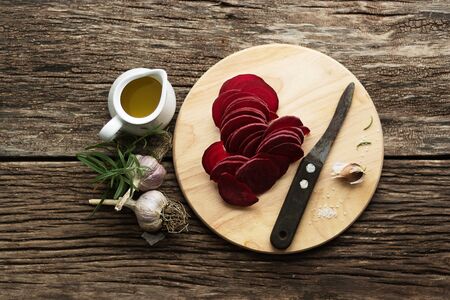 Beetroot Chips. The process of making snacks. Healthy handmade vegetable chips. On a cutting board,...