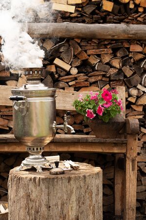 Tea Cermonia with a Russian samovar. Traveling in Russia. Traditional culture of peoples. Village lifestyle, fresh air and outdoor activities.の写真素材