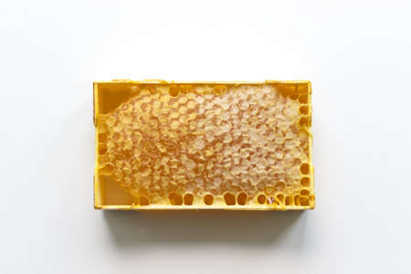 Fresh honey in a mini frame stands on a white background. Reserve vitamins for the winterの写真素材