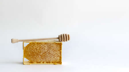 Fresh honey in a mini frame stands on a white background. Reserve vitamins for the winterの写真素材
