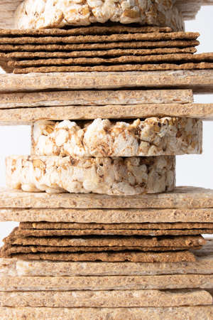 The crispbreads are stacked. Healthy crispy bread on a white background. Vegetarian and diet food. Close-up photo.の写真素材