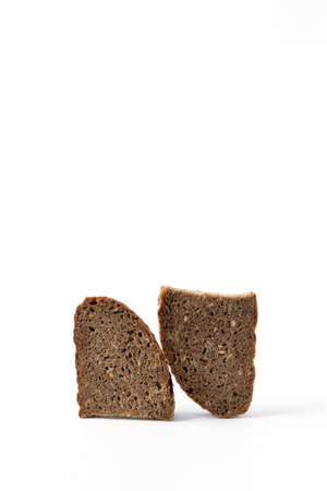 Two pieces of rye bread on a white background, triangular shape. Useful product.の写真素材