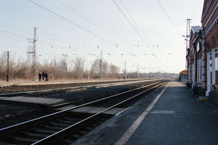 AKSAKOVO, REPUBLIC OF BASHKORTOSTAN, RUSSIA, APRIL 16, 2021: People meet the train of the Russian Railways at the stationのeditorial素材