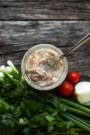 Stew in a glass jar on a wooden table.の写真素材